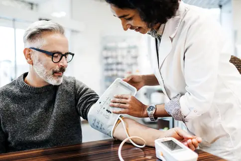 photo of pharmacist checking blood pressure