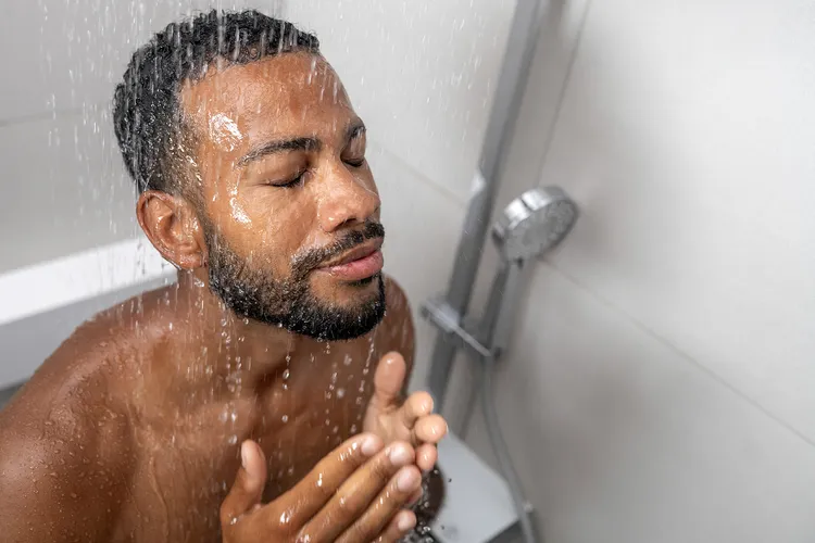 photo of man rinsing off in shower