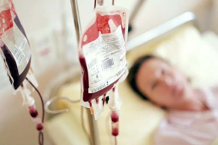 photo of female patient receiving blood transfusion