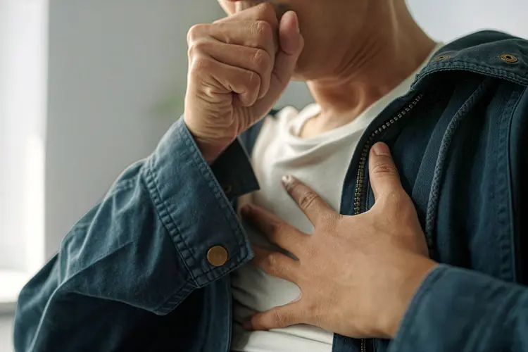 photo of young man coughing