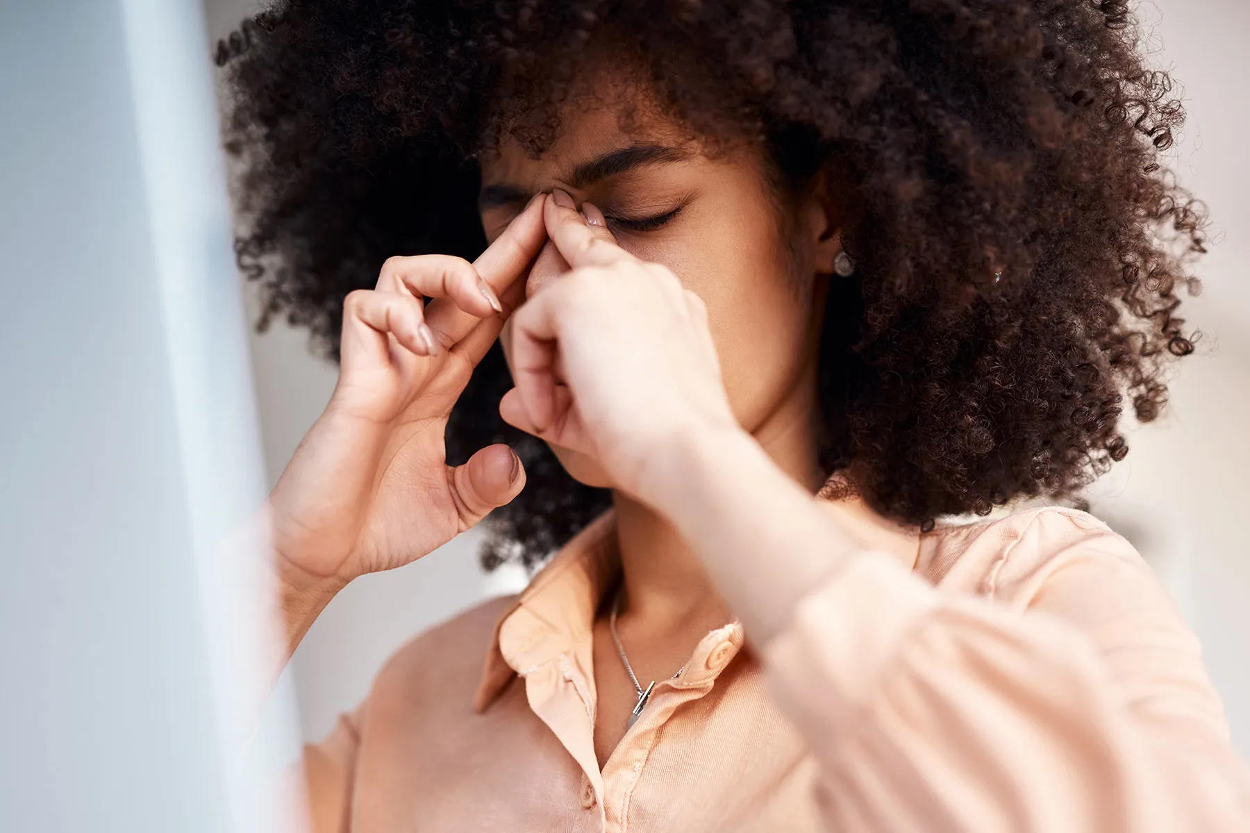 photo of young woman with sinus pain