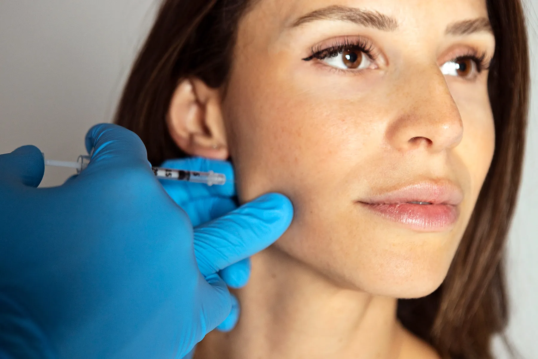 photo of woman getting injection in jaw