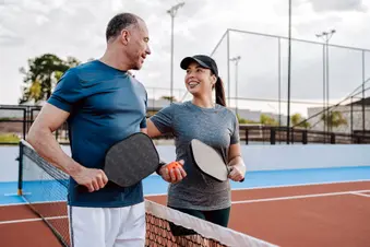 photo of mature couple on pickleball court