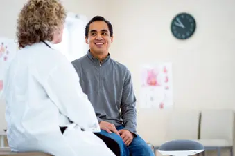 photo of male patient talking with doctor