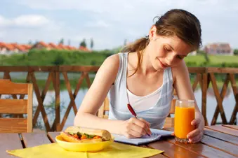 photo of woman writing in journal