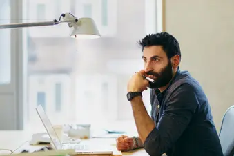 photo of man working at office desk