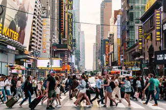 photo of crowd walking on city street