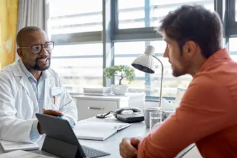 photo of doctor talking with male patient