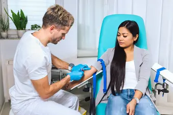 photo of nurse taking blood sample from woman