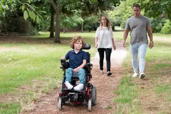 photo of boy and parents in park