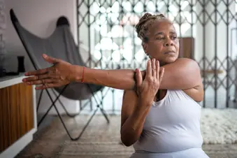 photo of senior woman stretching at home
