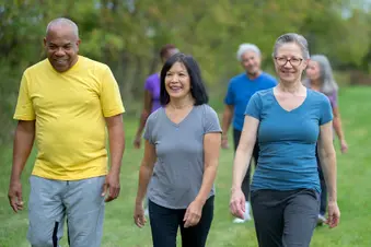 photo of group of mature friends walking for exercise