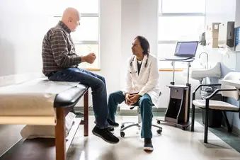 photo of senior male patient talking with doctor