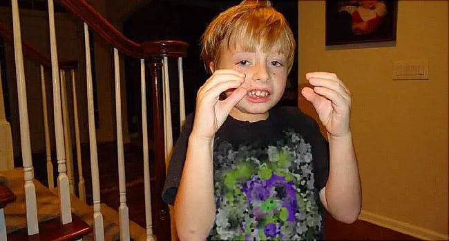 autistic boy waving hands