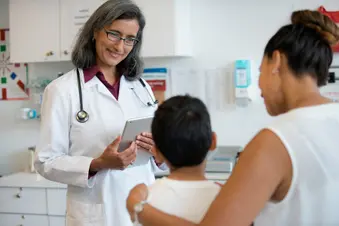 photo of doctor talking to child and parent