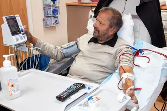 photo of senior man receiving dialysis treatment
