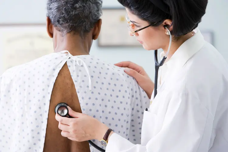 photo of doctor listening to patient breathing wit