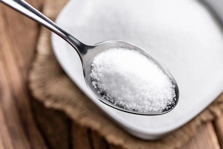 photo of white sugar in spoon
