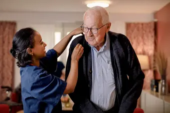 photo of nurse helping senior man