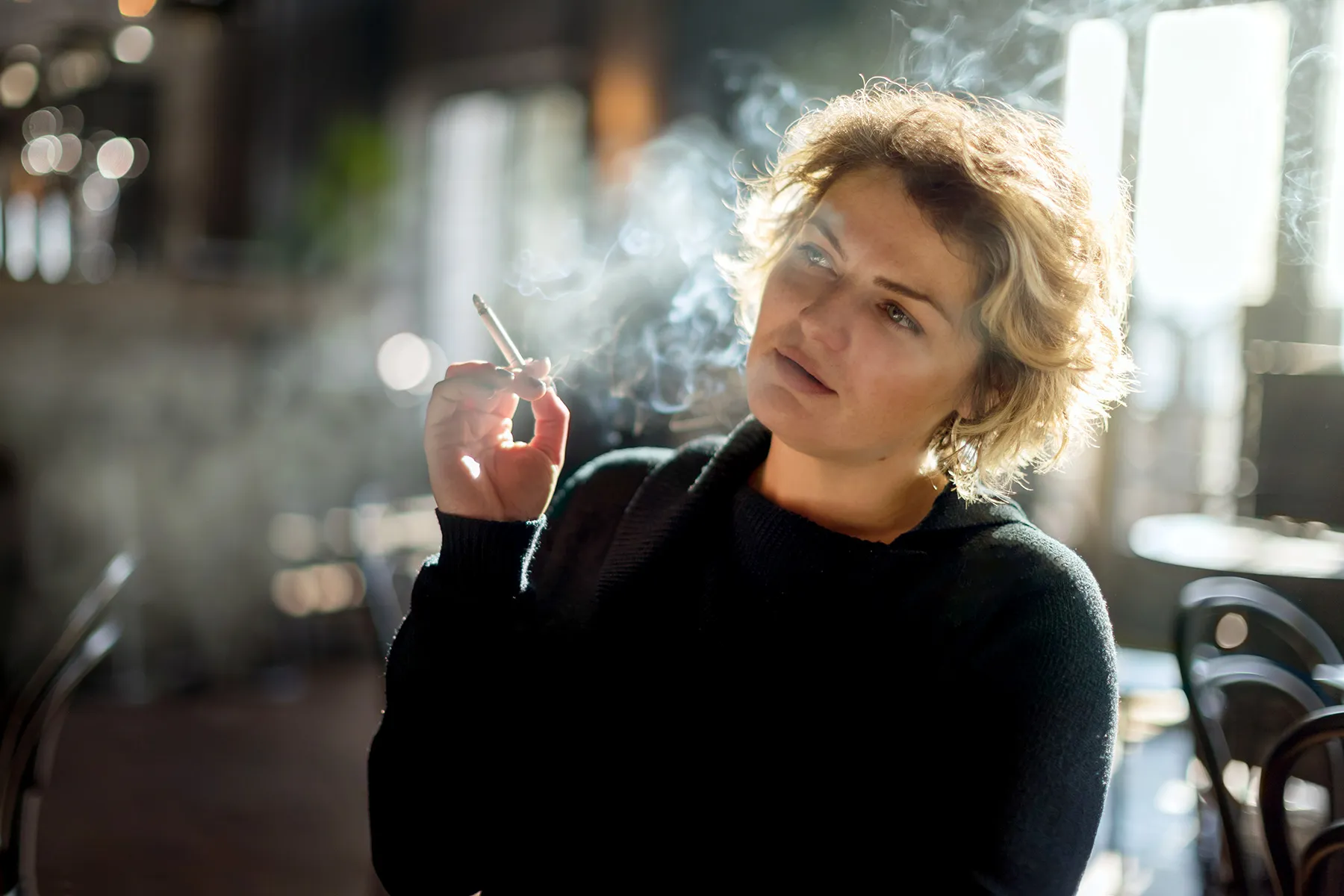 photo of woman smoking in restaurant
