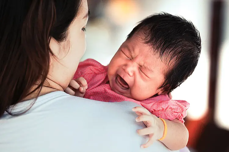 mother comforting crying baby