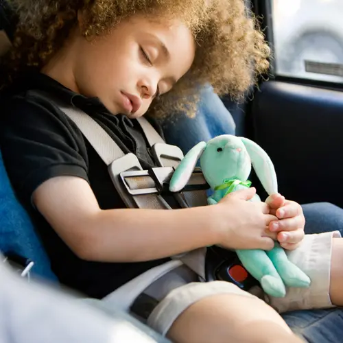 photo of boy asleep in car seat