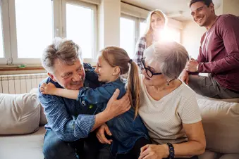 photo of grandparents playing with grandchild