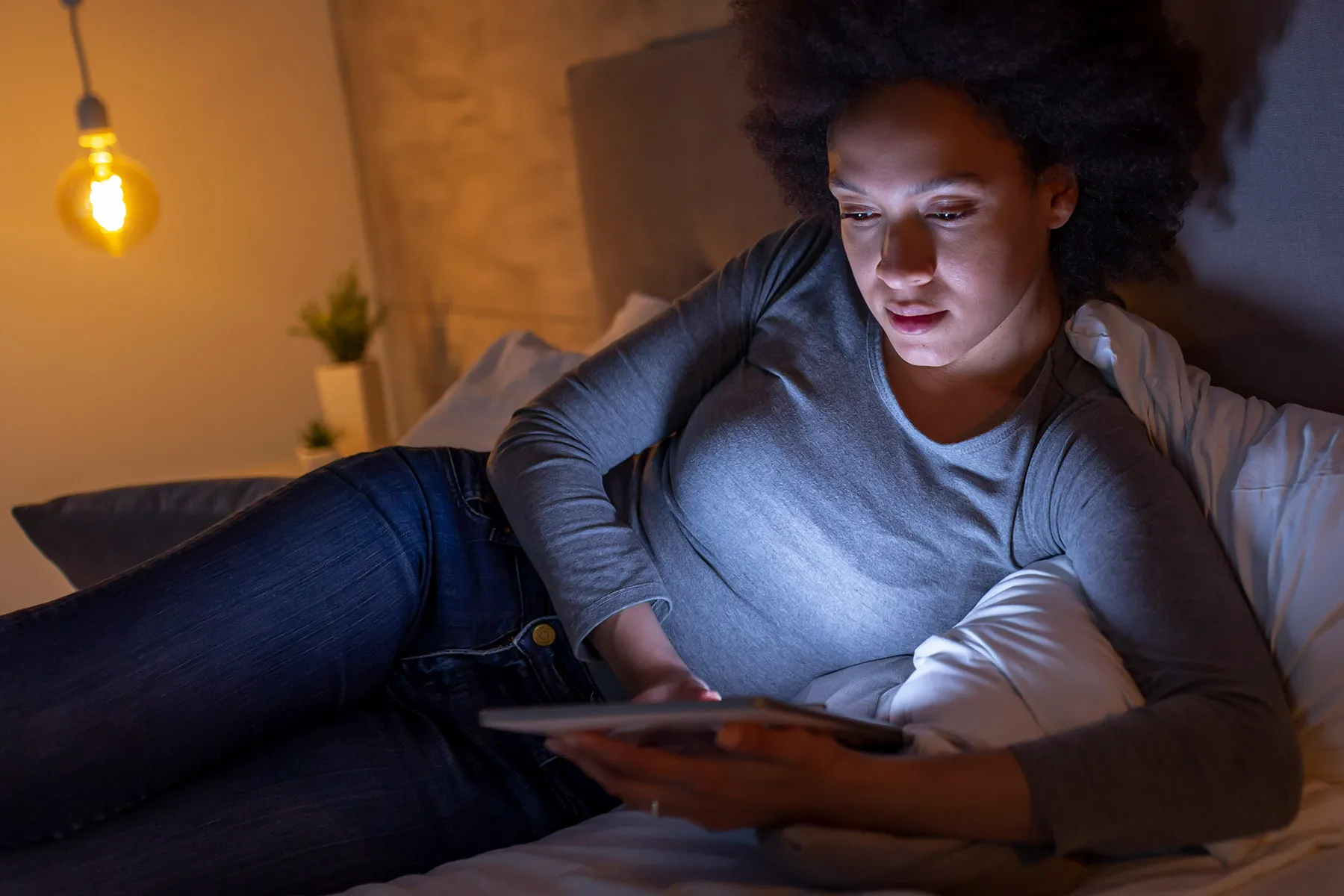 photo of woman using computer tablet