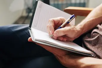 photo of person writing in journal