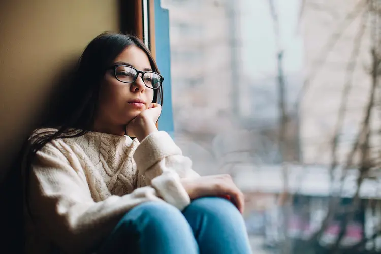 depressed woman by window