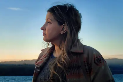 photo of woman looking at sunset
