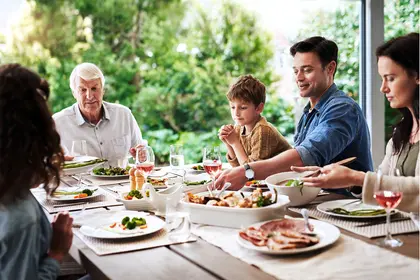 photo of family eating lunch together outdoors