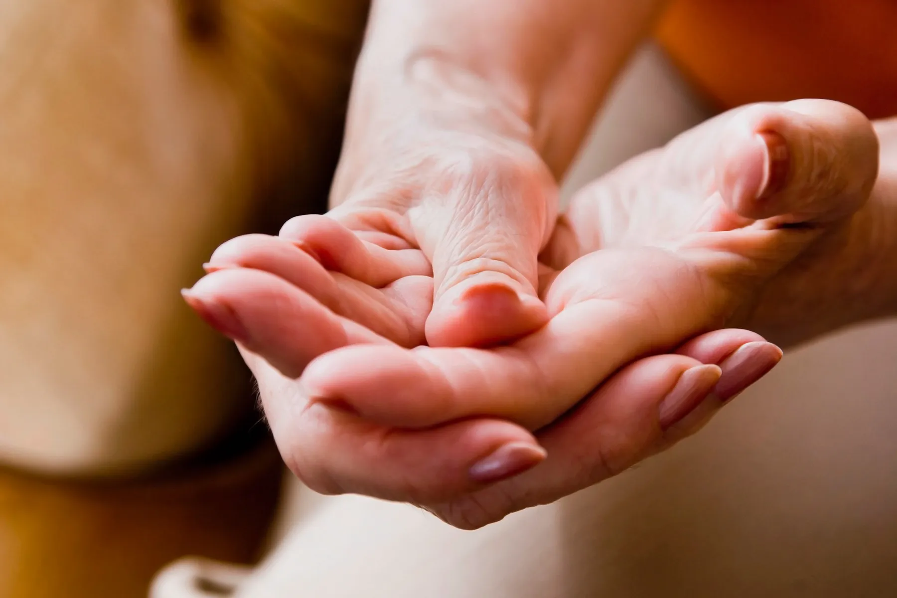 photo of woman massaging sore hand