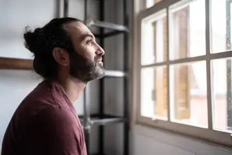 photo of man looking out window