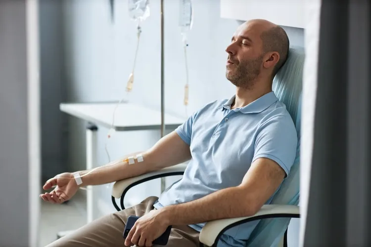photo of man getting iv in chemotherapy room