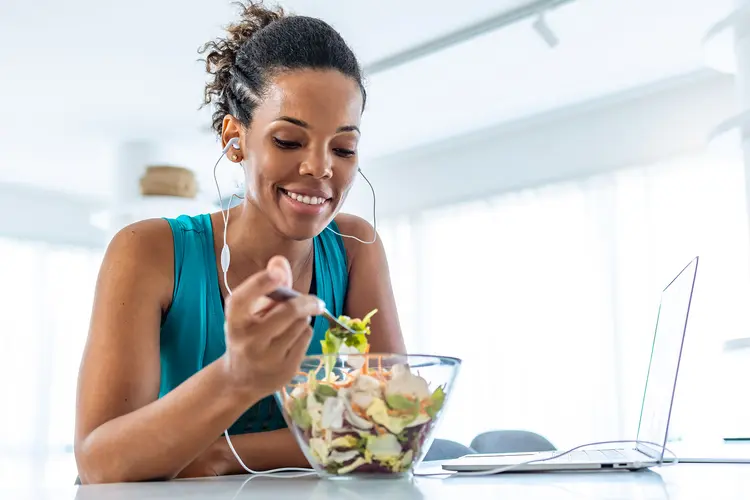 photo of woman eating salad