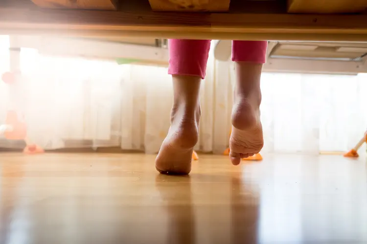 photo of woman getting out of bed