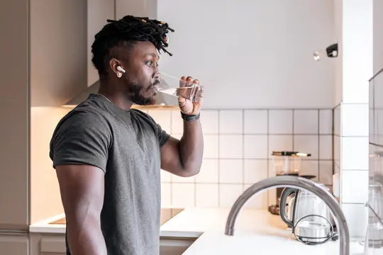 photo of man drinking glass of water
