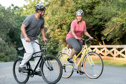 photo of mature couple riding bicycles