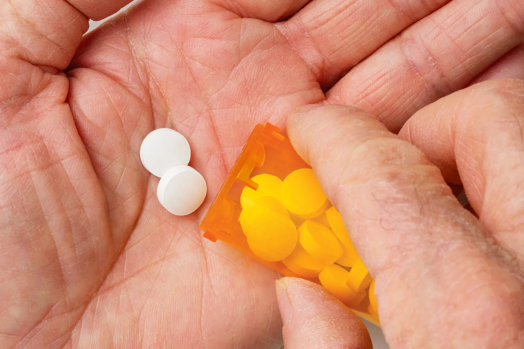 photo of pouring prescription pills in hand