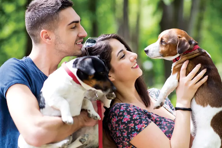 photo of couple outside with their dogs
