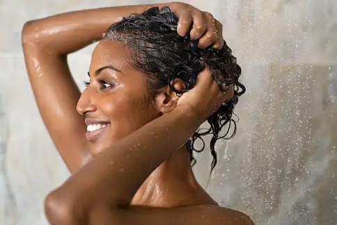 photo of woman washing hair in shower