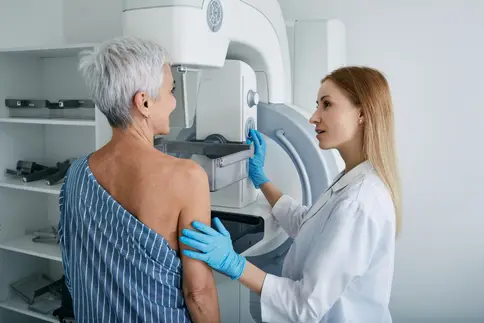 photo of woman screening for breast cancer with doctor