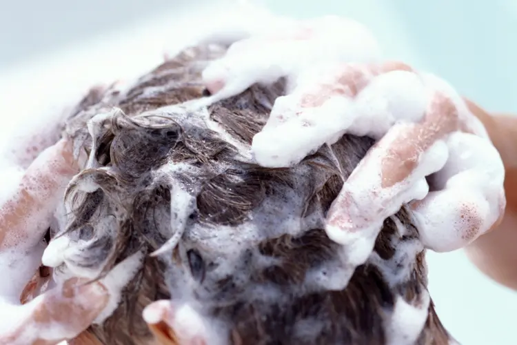 close up photo of person washing their hair and lathering shampoo