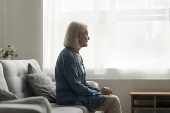 photo of older woman looking out the window