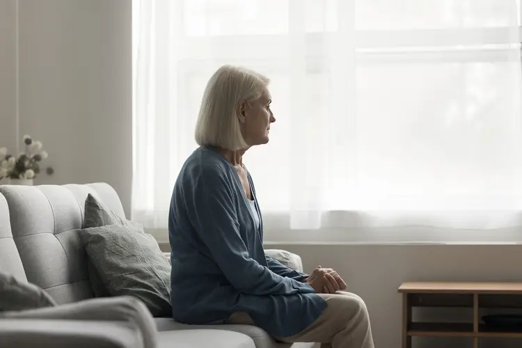 photo of older woman looking out the window