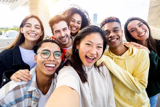 photo of Diverse group of happy young having fun and taking selfie photo together