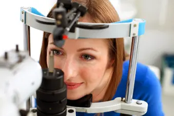 photo of woman getting an eye exam