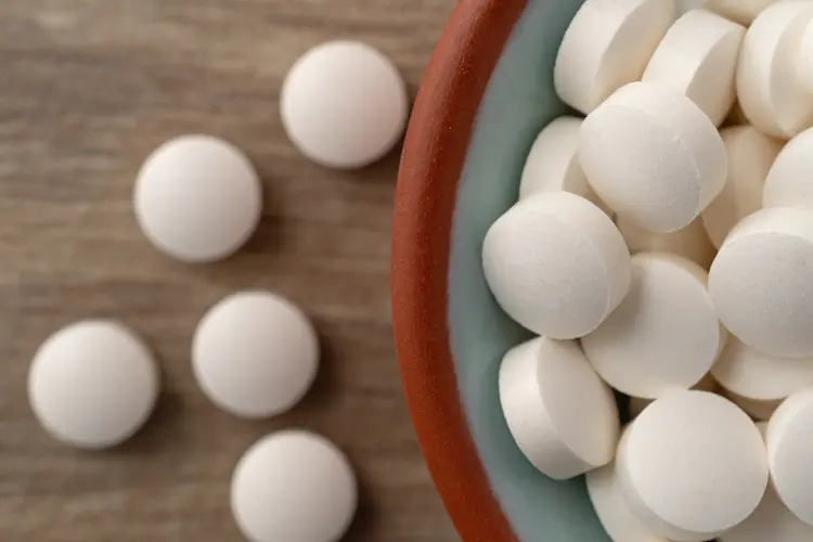 A photo of DHEA supplements in the form of white, round pills