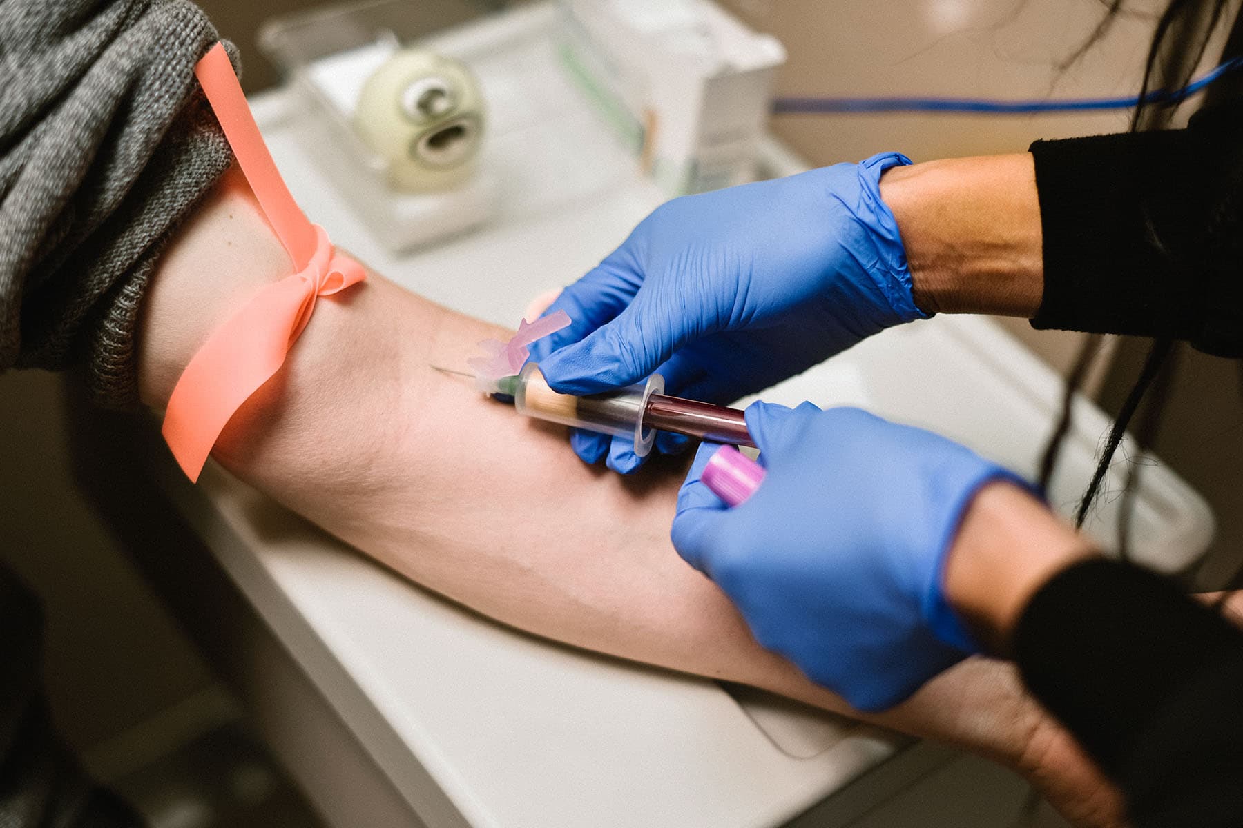 photo of drawing blood mans arm